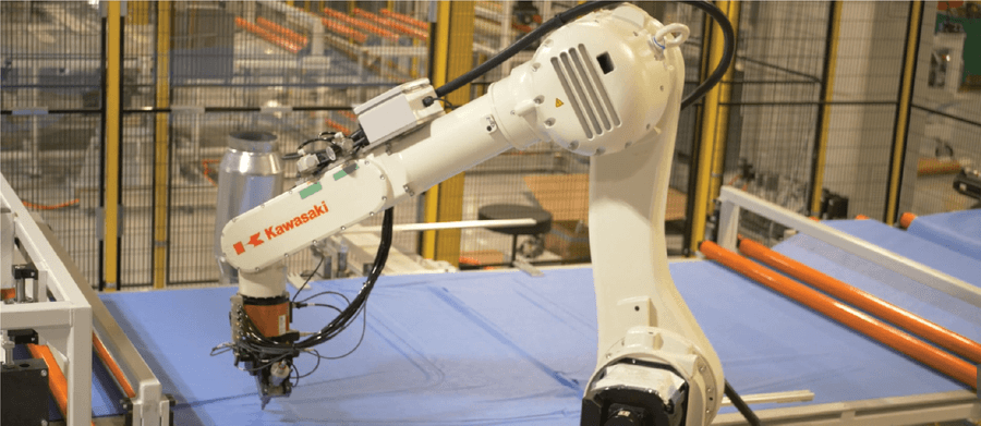 Kawasaki robot uses knife tool to cut out isolation gowns.