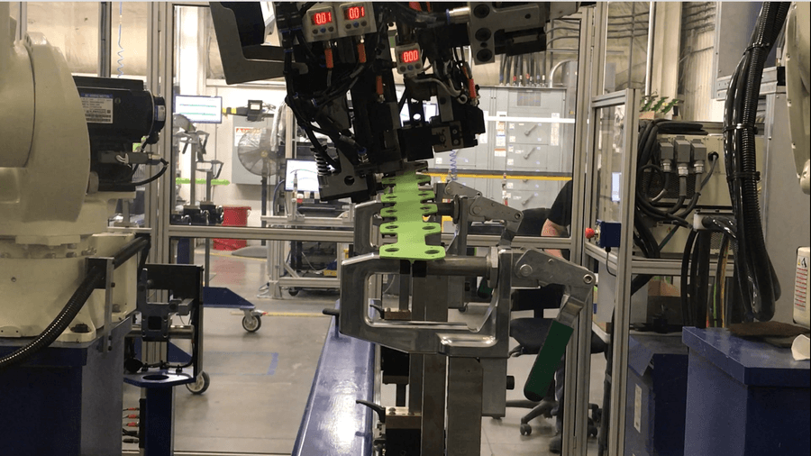 Kawasaki robots work together to install nutplate rivets